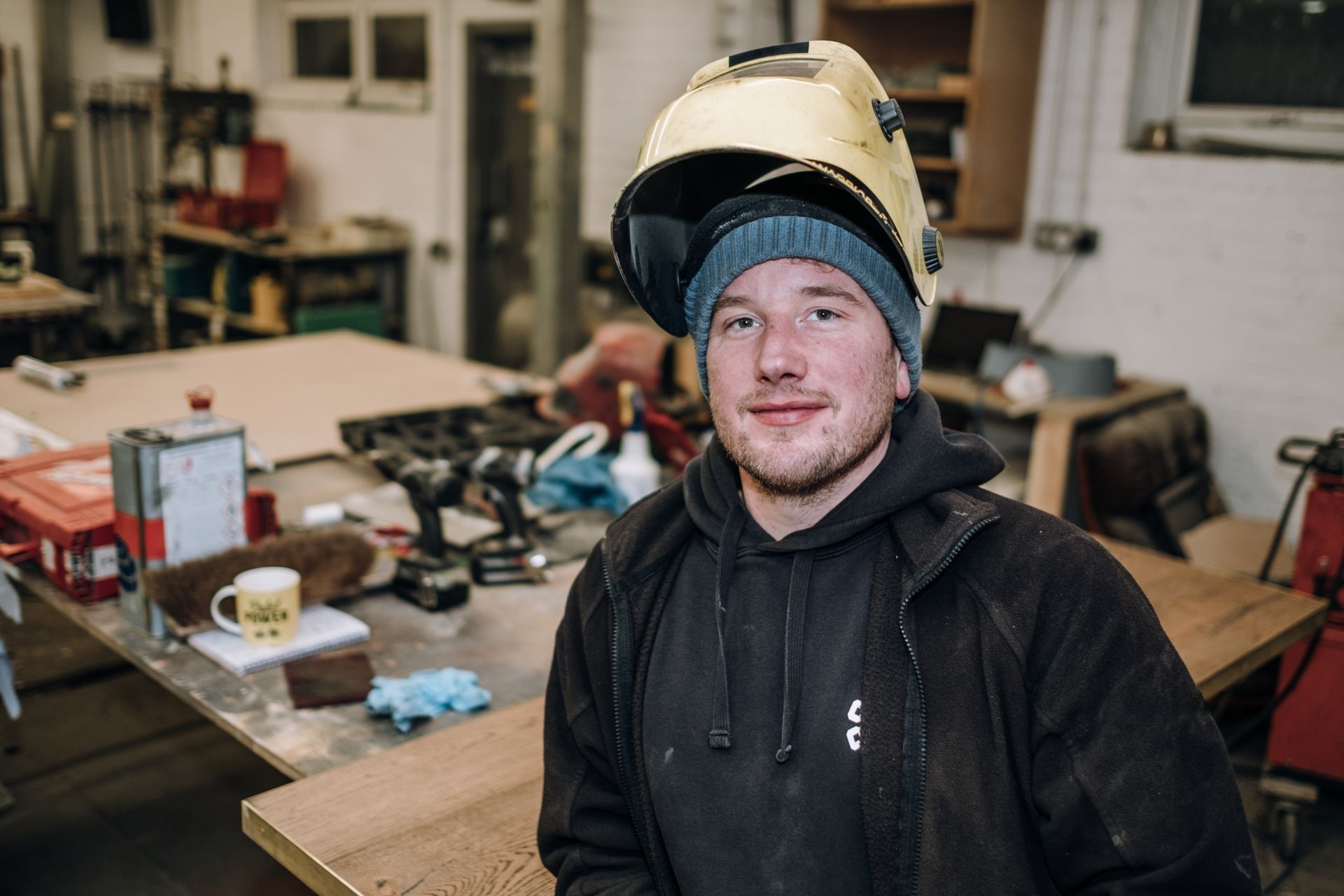 Portrait of cheerful young worker posing looking at camera and s